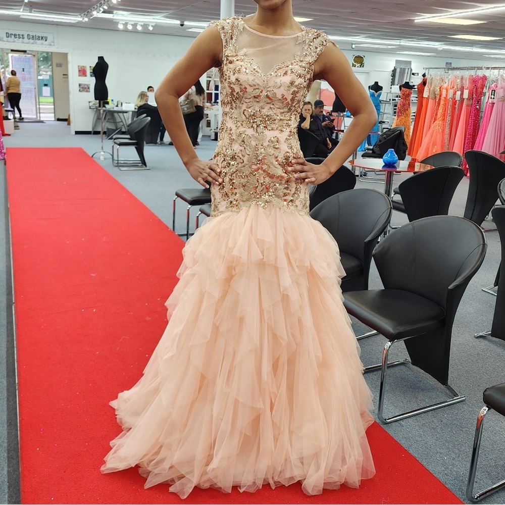 Pink and rose gold prom dress with beaded detail and a tulle skirt.